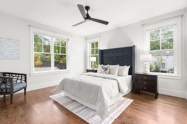 a bed sitting in a bedroom next to a window