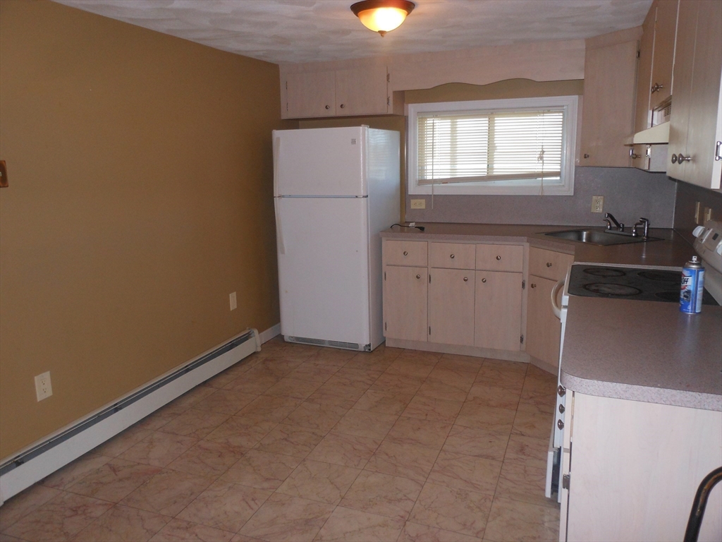 21 Cook, Unit 1 Chelsea, MA 02150 - Photo 23 of 32 a utility room with cabinets washer and dryer