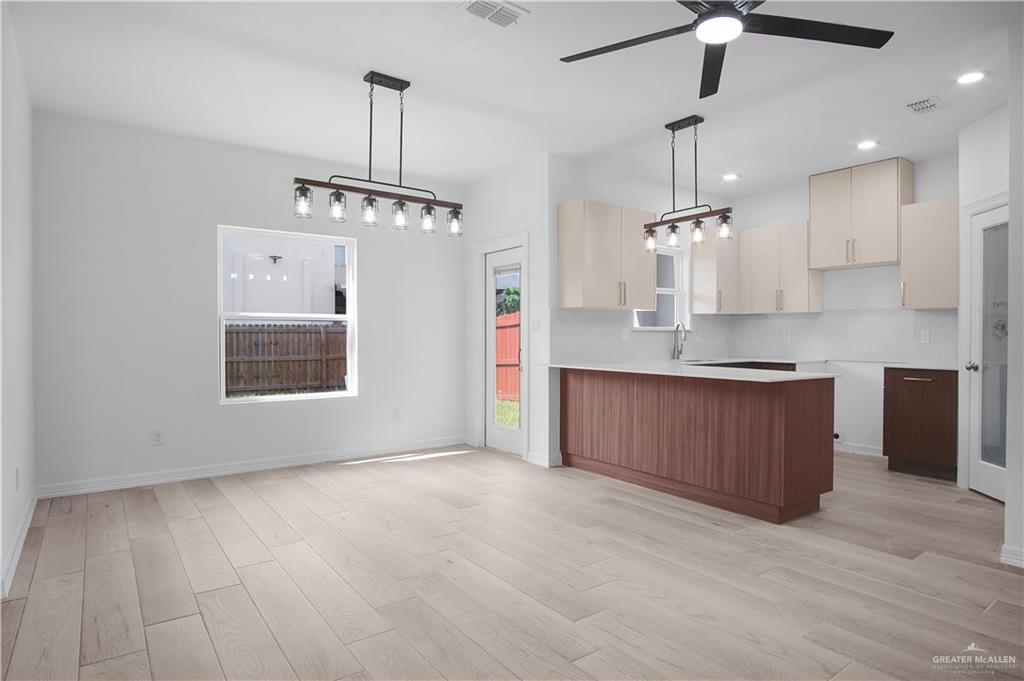 2310 Corales Street Mission, TX 78573 - Photo 3 of 23 a kitchen with stainless steel appliances granite countertop a refrigerator a sink dishwasher and a wooden cabinets