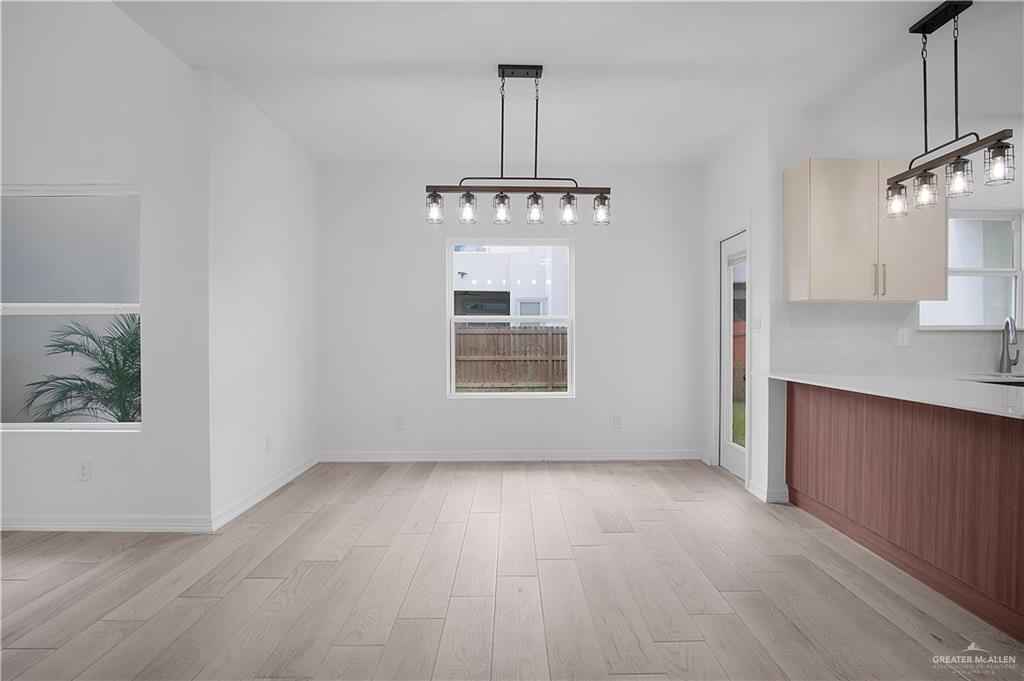 2310 Corales Street Mission, TX 78573 - Photo 4 of 23 a view of a room with window wooden floor and chandelier