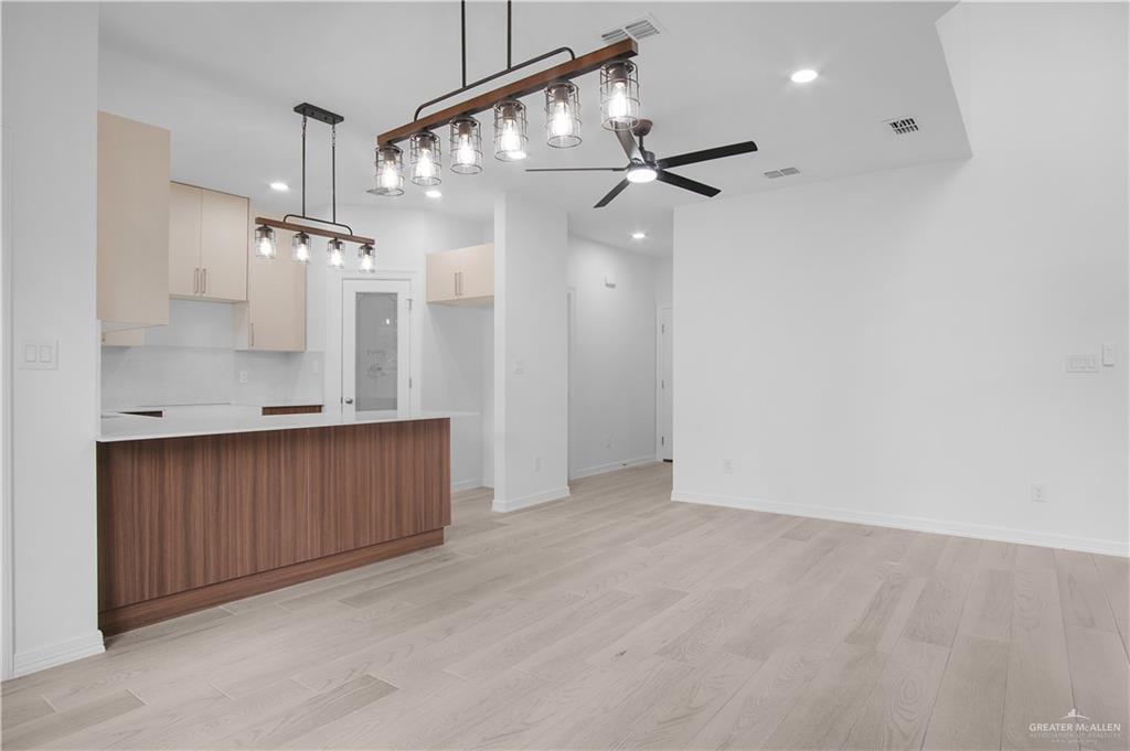 2310 Corales Street Mission, TX 78573 - Photo 7 of 23 an empty room with a mirror and a ceiling fan