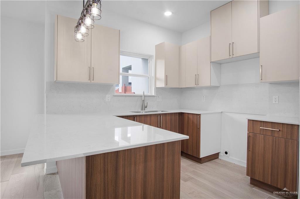2310 Corales Street Mission, TX 78573 - Photo 8 of 23 a kitchen with stainless steel appliances a sink a stove a refrigerator and cabinets