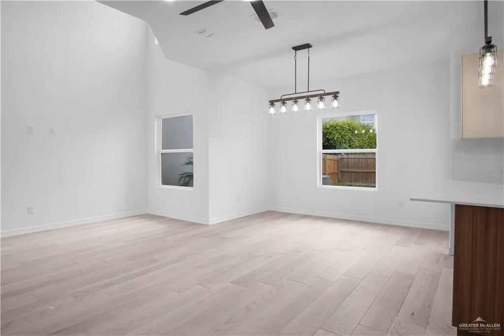 2310 Corales Street Mission, TX 78573 - Photo 9 of 23 an empty room with windows and ceiling fan