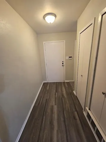 a view of a room with wooden floor