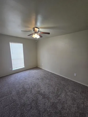 a view of a room with a ceiling fan and a chandelier fan