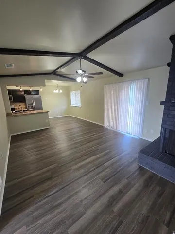 a view of a room with wooden floor