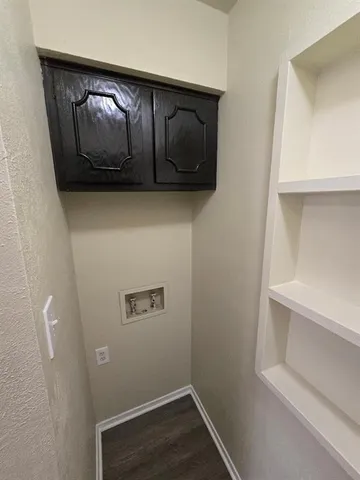 a hallway with wooden cabinet with wooden floor
