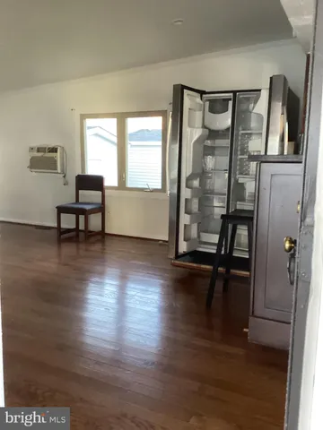 a view of a livingroom with furniture and hardwood floor