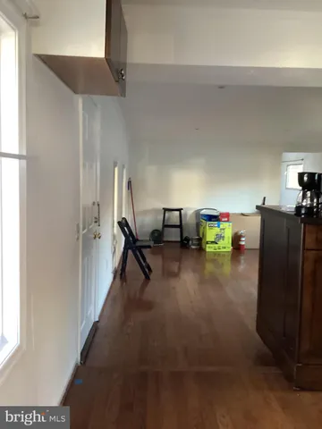 a kitchen with granite countertop a sink cabinets and wooden floor