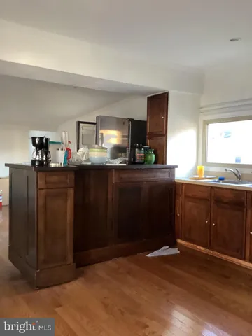 a kitchen with stainless steel appliances kitchen island granite countertop a stove top oven