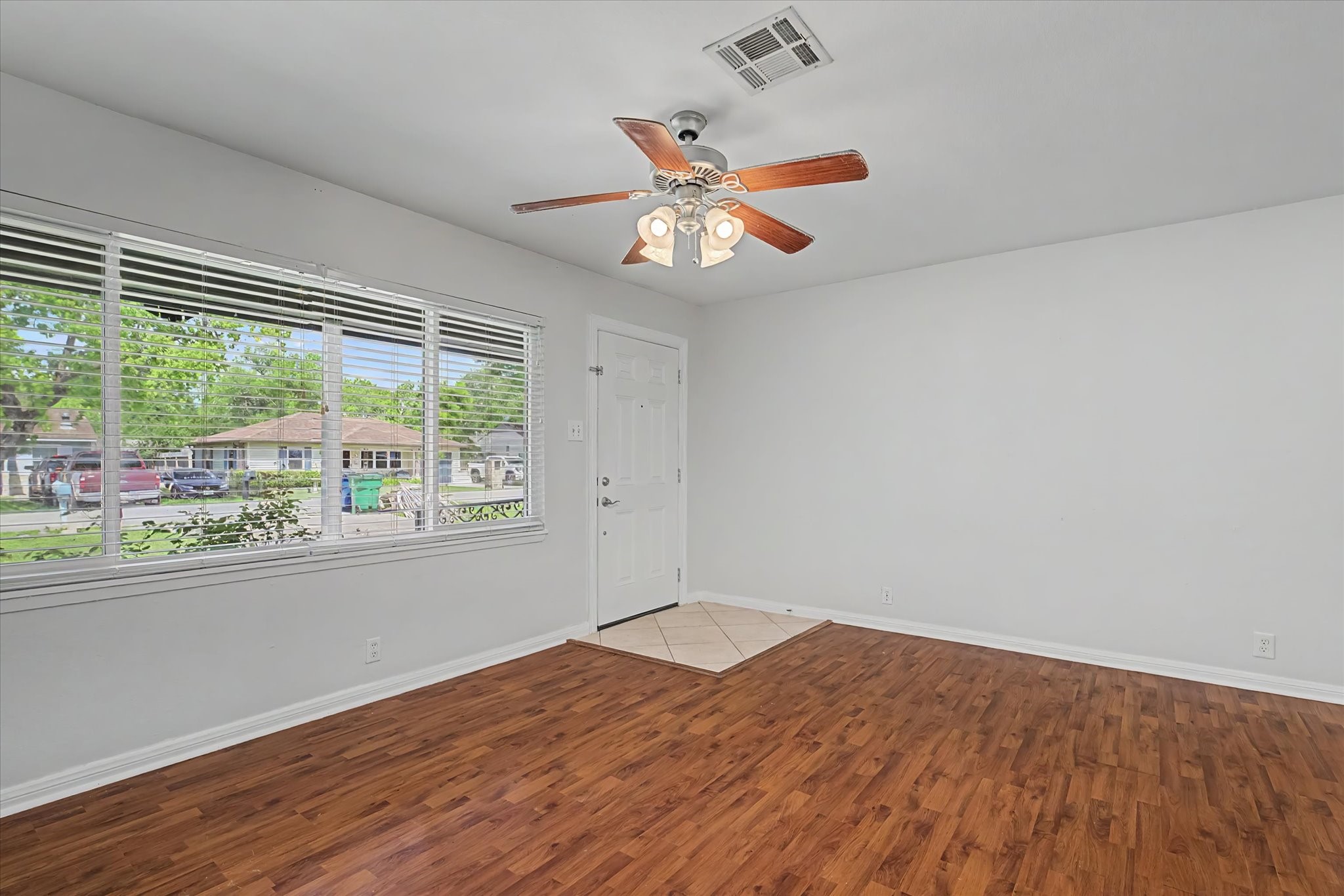 413 Farrer Street Angleton, TX 77515 - Photo 9 of 43 wooden floor in an empty room with a window