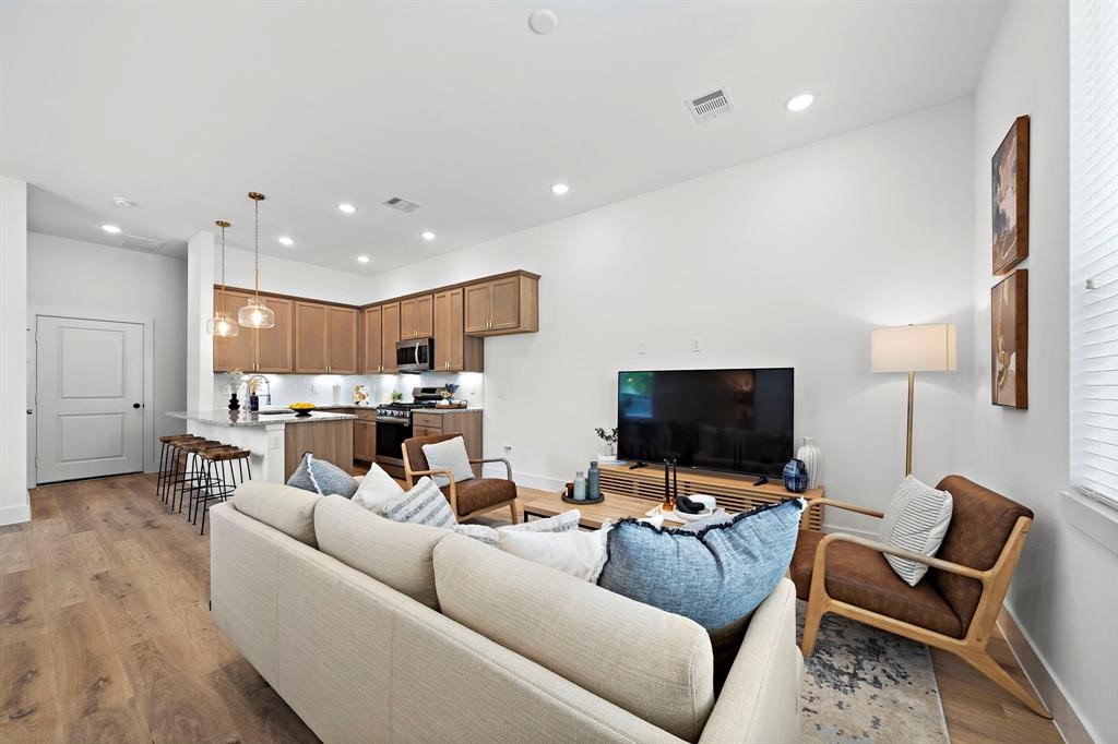 1586 West Tidwell Road Houston, TX 77091 - Photo 1 of 14 a living room with furniture and a flat screen tv