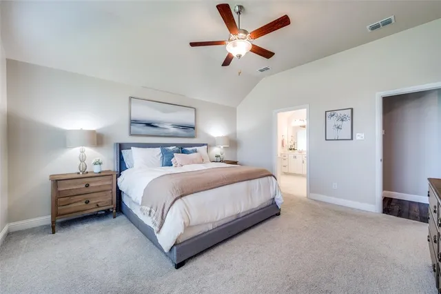 a bedroom with a bed and a ceiling fan