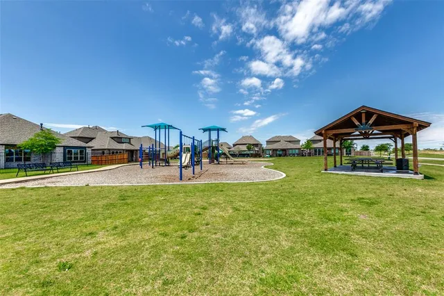a view of a house with swimming pool and sitting area