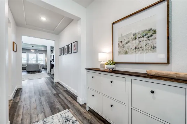 a view of a hallway with wooden floor