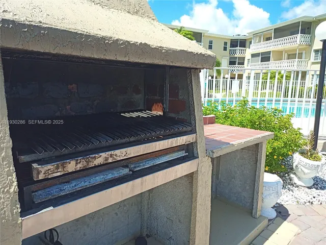 a outdoor space with barbeque grill and outdoor seating