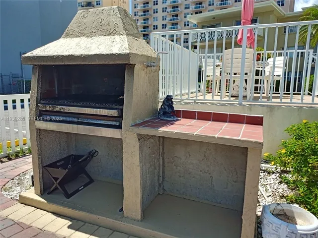 a terrace with wooden bench and potted plants