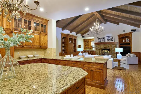 a kitchen with stainless steel appliances granite countertop a stove a sink dishwasher and cabinets with wooden floor