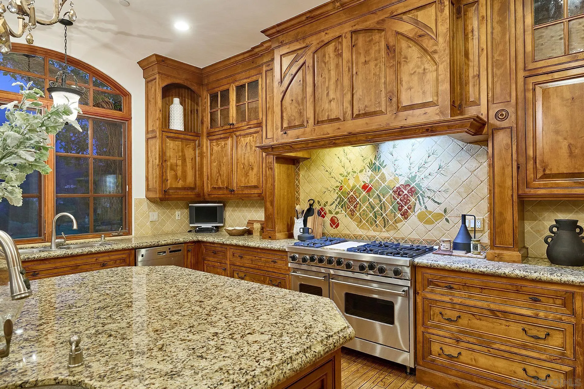 14155 Biscayne Place Poway, CA 92064 - Photo 16 of 56 a kitchen with stainless steel appliances granite countertop a stove and a sink