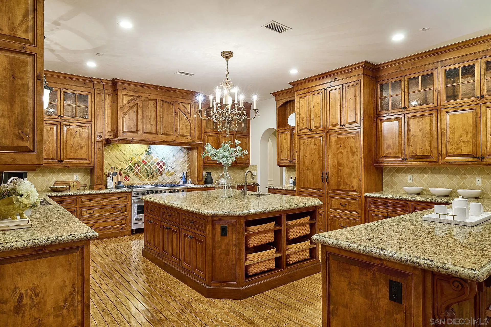 14155 Biscayne Place Poway, CA 92064 - Photo 17 of 54 a kitchen with stainless steel appliances granite countertop a stove a sink dishwasher and cabinets with wooden floor