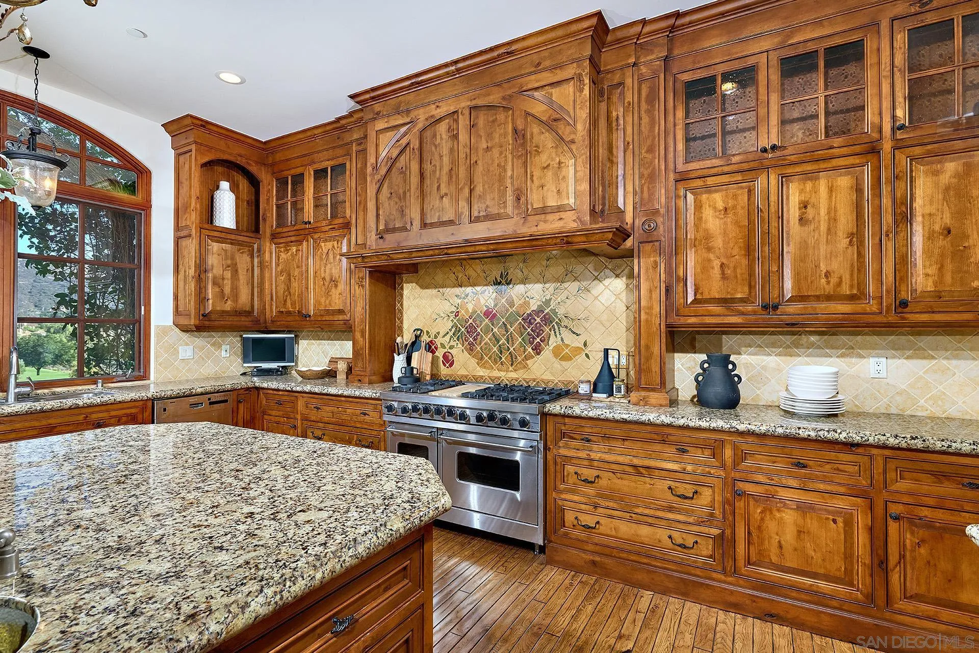 14155 Biscayne Place Poway, CA 92064 - Photo 23 of 56 a kitchen with stainless steel appliances granite countertop a stove a sink and a microwave