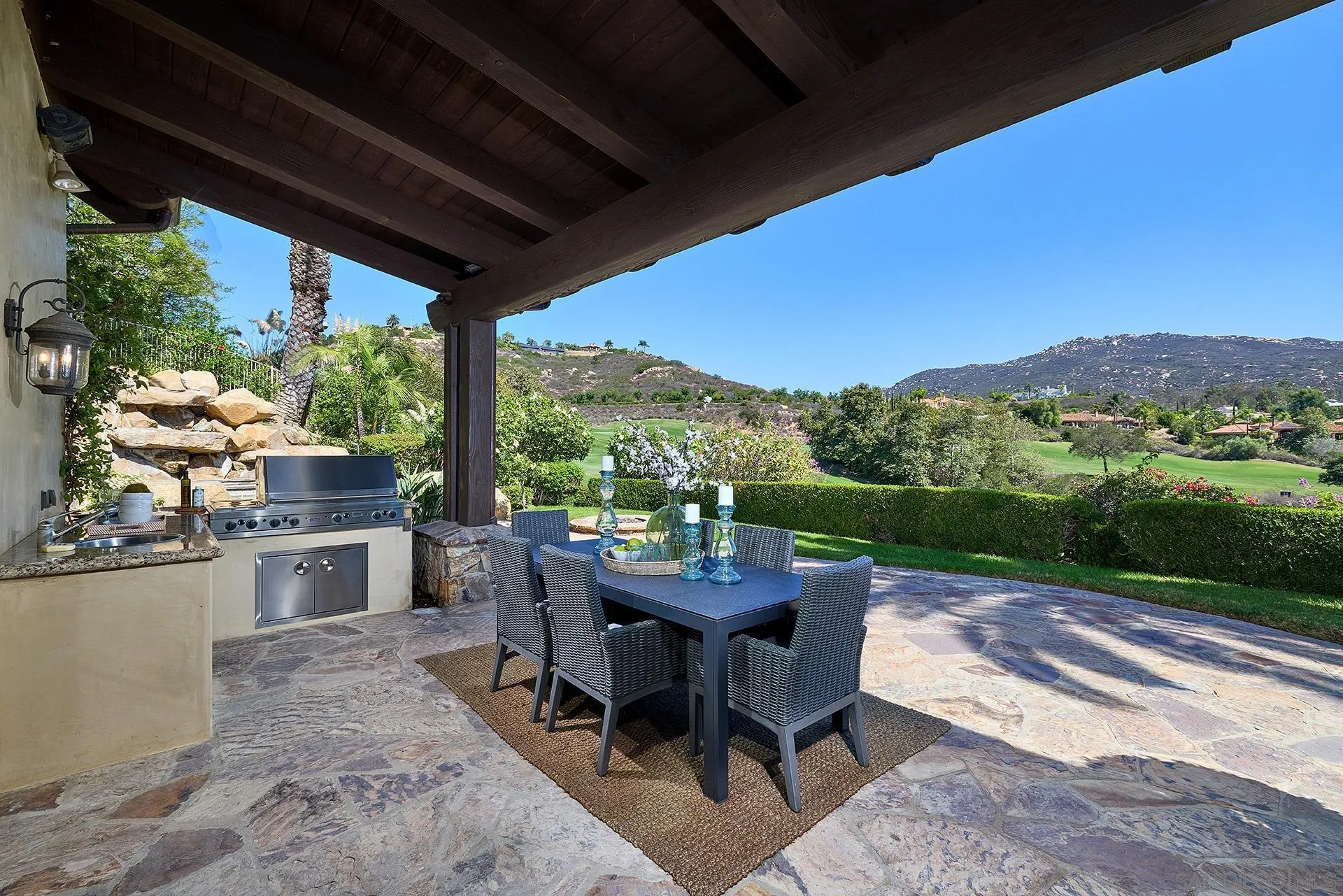 14155 Biscayne Place Poway, CA 92064 - Photo 37 of 56 a view of a patio with a table chairs and a backyard