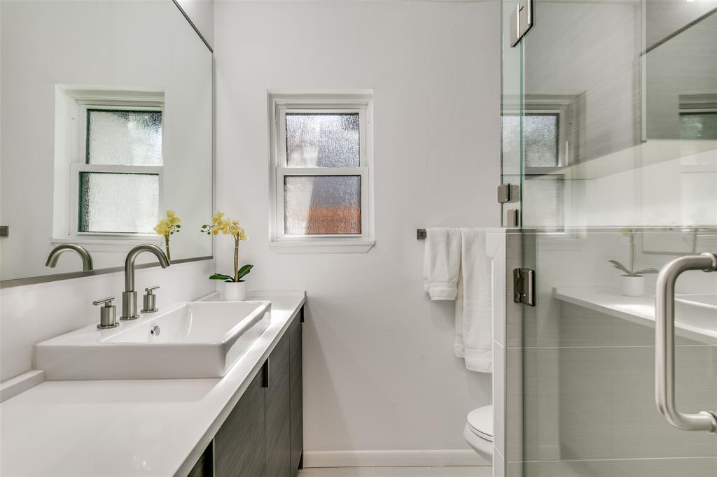 5117 Maple Springs Boulevard Dallas, TX 75235 - Photo 11 of 15 a bathroom with a sink a toilet and shower