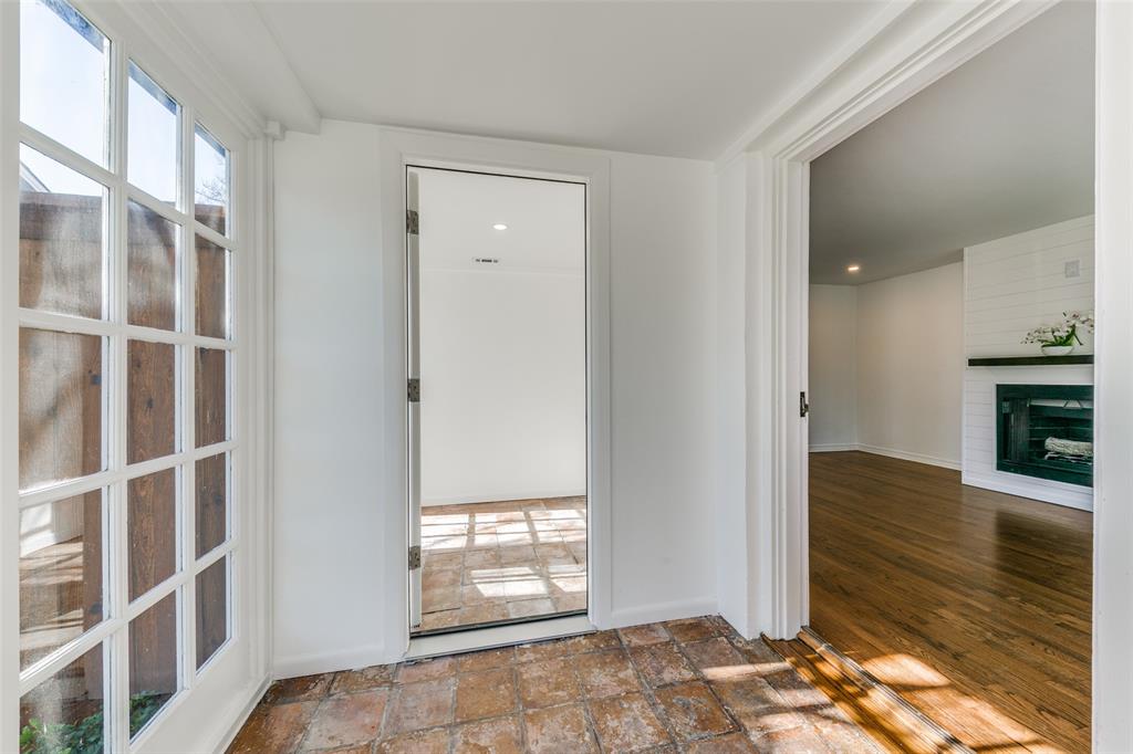 5117 Maple Springs Boulevard Dallas, TX 75235 - Photo 3 of 15 a view of an empty room with a window and wooden floor