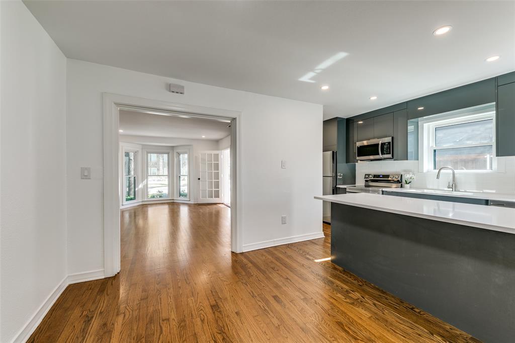 5117 Maple Springs Boulevard Dallas, TX 75235 - Photo 6 of 15 a view of a kitchen with wooden floor and a sink