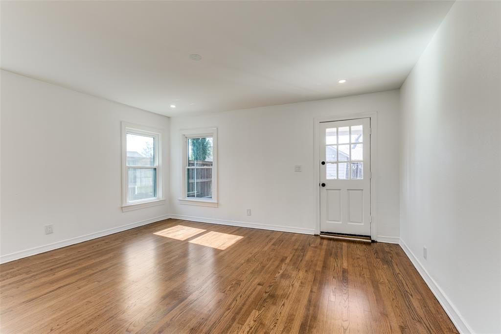 5117 Maple Springs Boulevard Dallas, TX 75235 - Photo 10 of 15 an empty room with wooden floor and windows