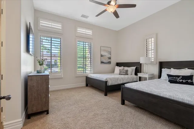 a view of a house with a yard chairs and table in a patio