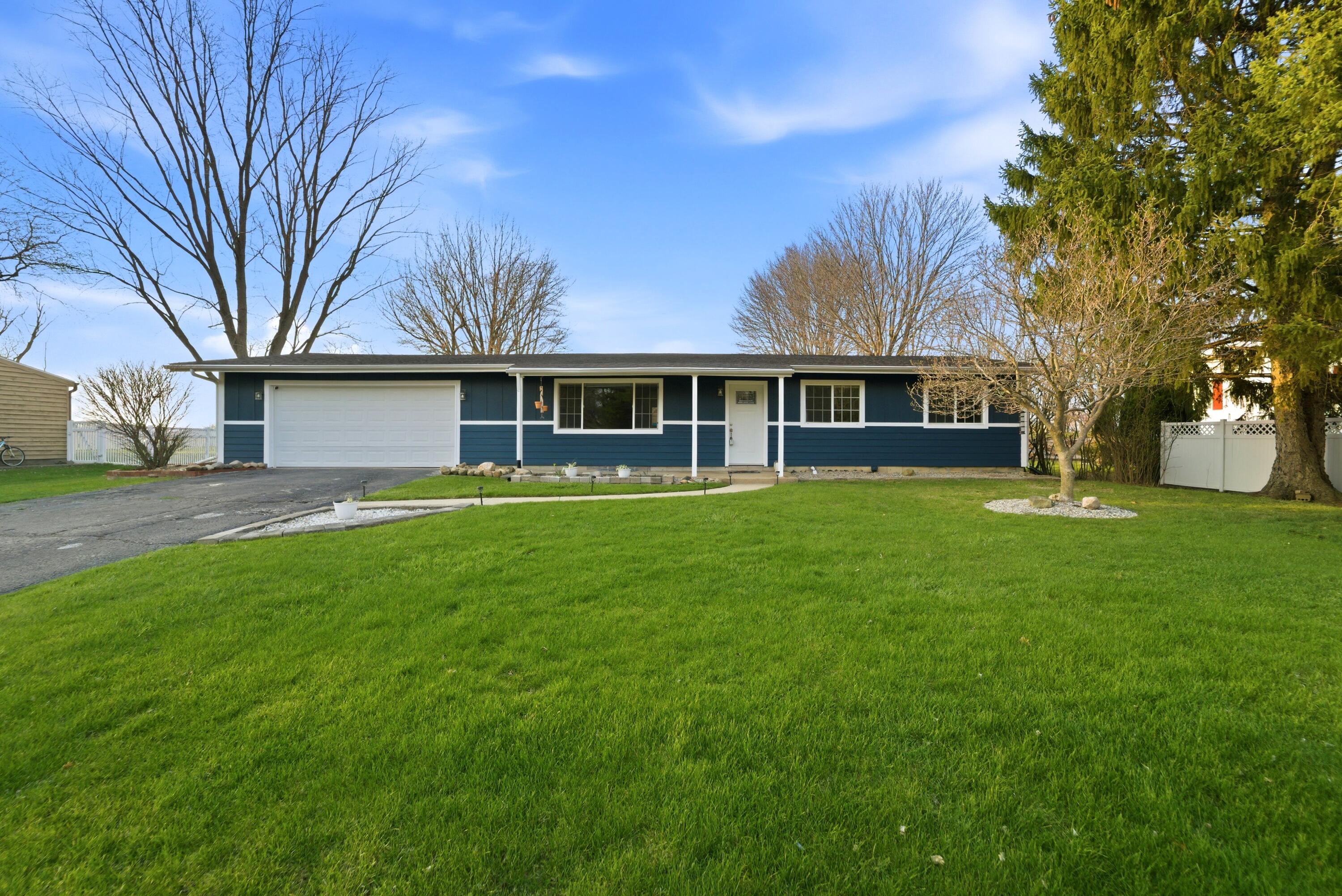 579 Fargo Road Westville, IN 46391 - Photo 1 of 35 a front view of a house with garden and trees
