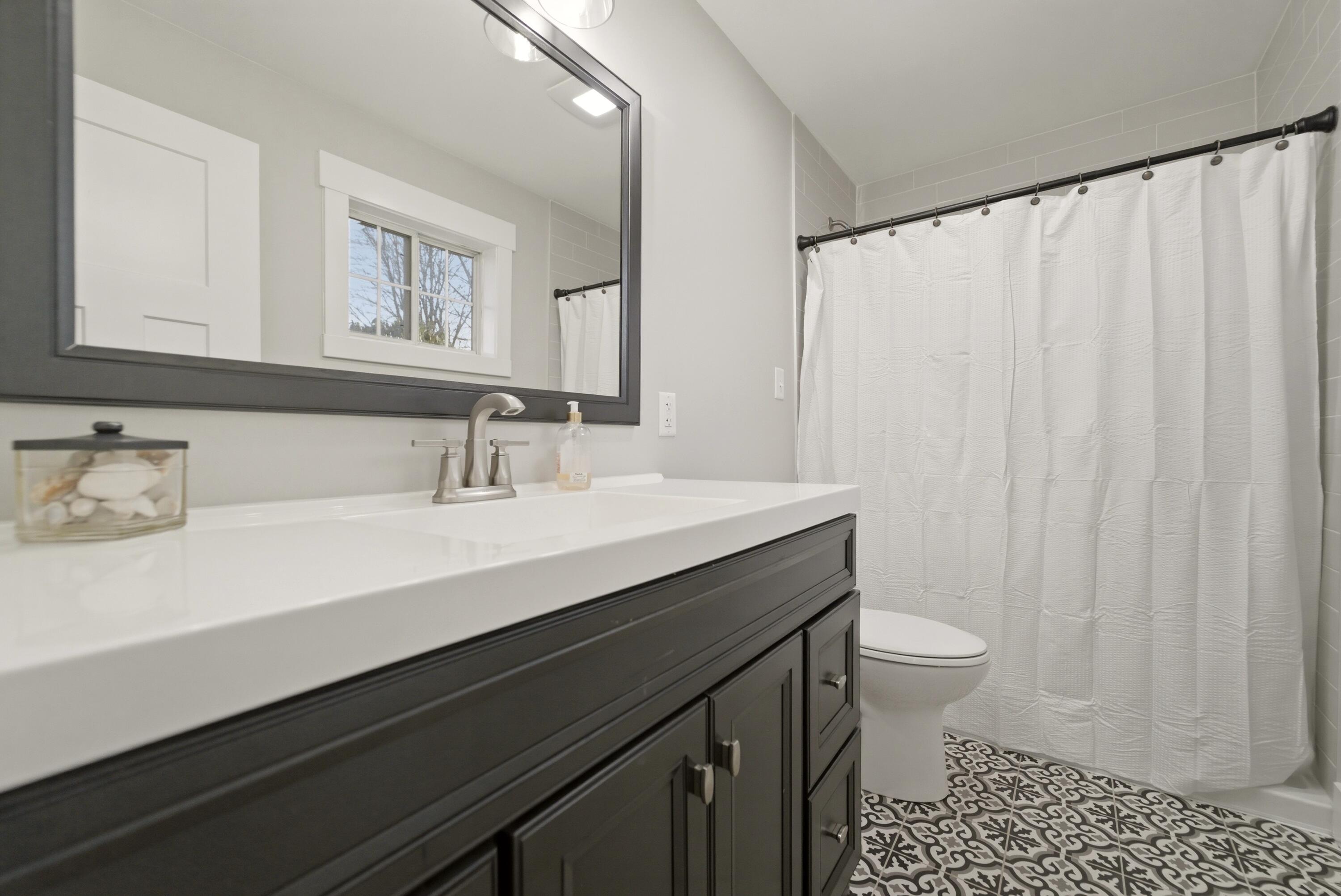 579 Fargo Road Westville, IN 46391 - Photo 17 of 35 a bathroom with a sink a toilet a mirror and shower curtain