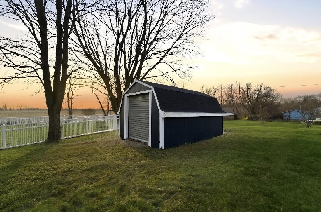 579 Fargo Road Westville, IN 46391 - Photo 31 of 35 a view of backyard with large tree and wooden fence
