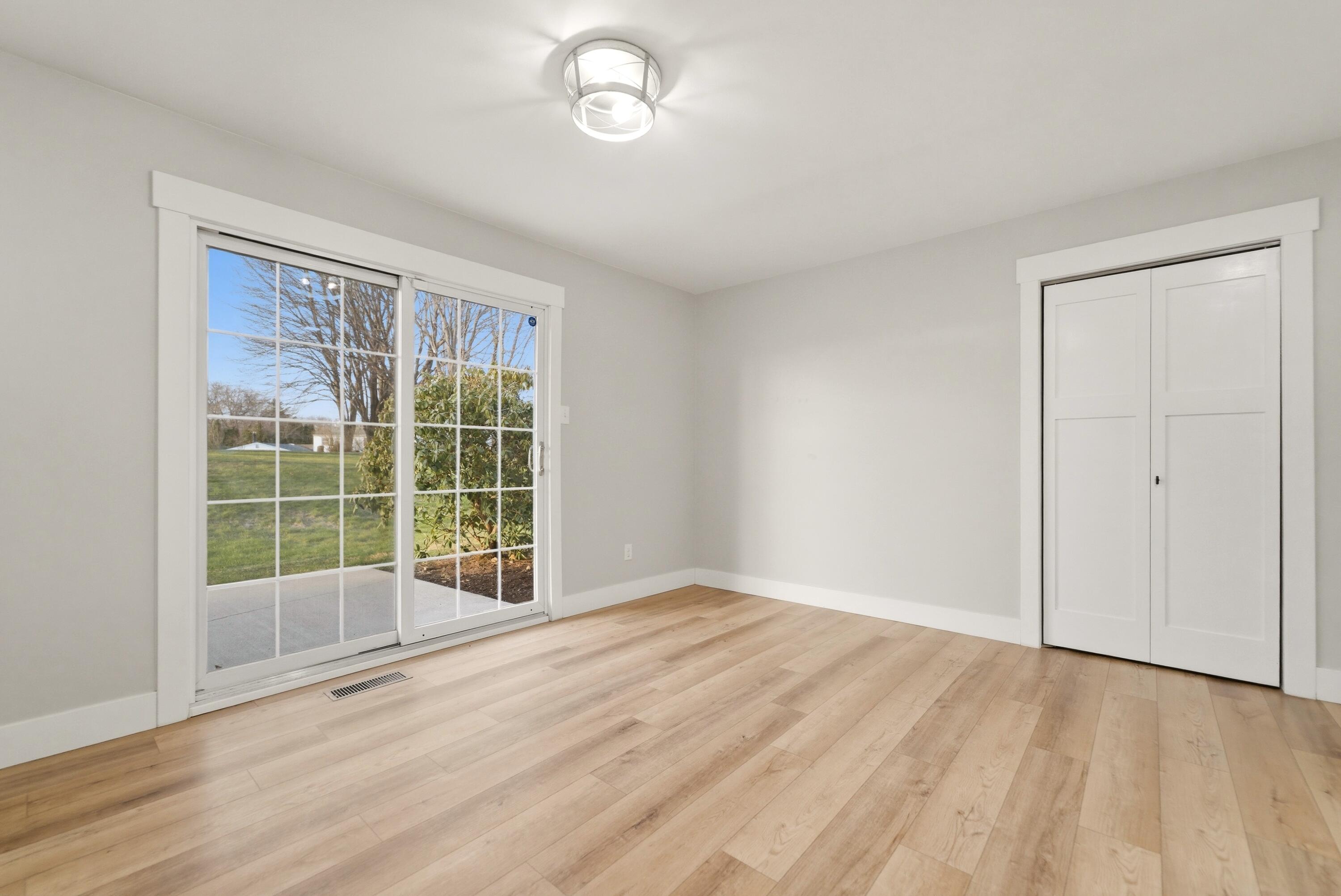 579 Fargo Road Westville, IN 46391 - Photo 5 of 35 an empty room with wooden floor and windows