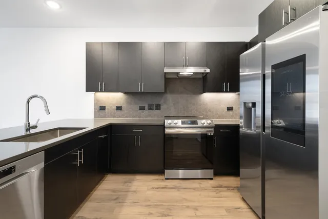a view of a terrace with lawn chairs and wooden floor