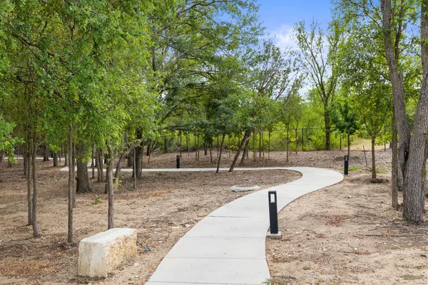 a view of a kitchen with kitchen island a sink stainless steel appliances and cabinets