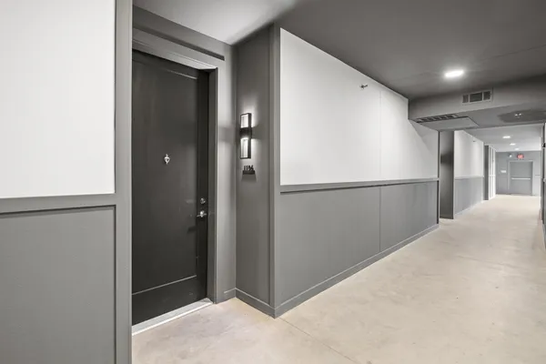 a bathroom with a granite countertop sink a toilet and a mirror