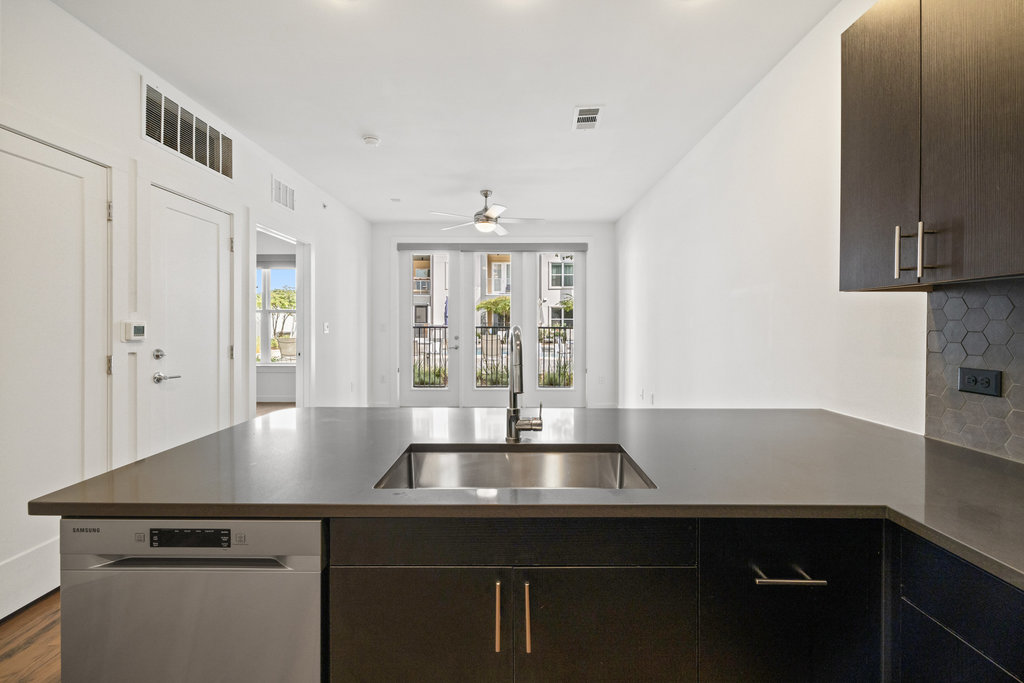 4801 Springdale Road, Unit 1106 Austin, TX 78723 - Photo 35 of 40 a kitchen with a sink and chandelier