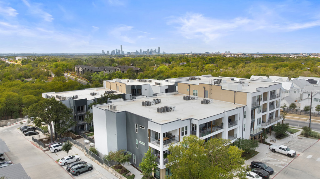 4801 Springdale Road, Unit 1106 Austin, TX 78723 - Photo 4 of 40 a view of a terrace with lawn chairs and wooden floor