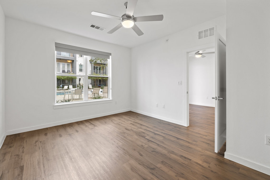 4801 Springdale Road, Unit 1106 Austin, TX 78723 - Photo 7 of 40 wooden floor in an empty room with a window