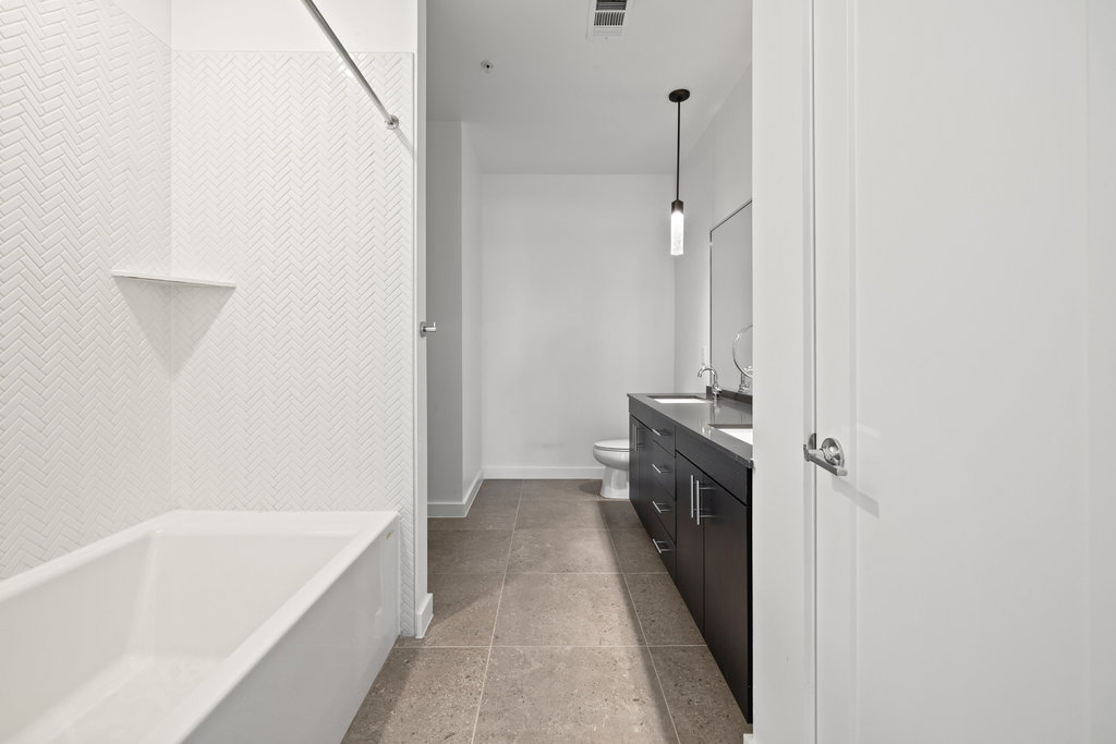 4801 Springdale Road, Unit 1106 Austin, TX 78723 - Photo 8 of 40 a bathroom with a bathtub and a shower