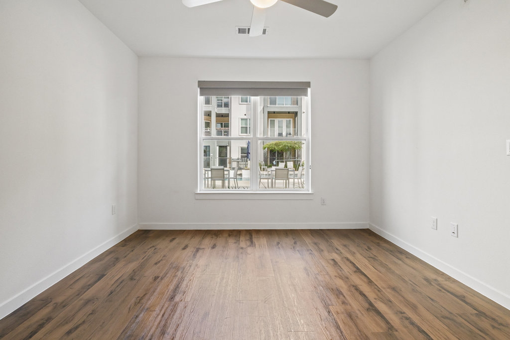 4801 Springdale Road, Unit 1106 Austin, TX 78723 - Photo 10 of 40 wooden floor in an empty room with a window