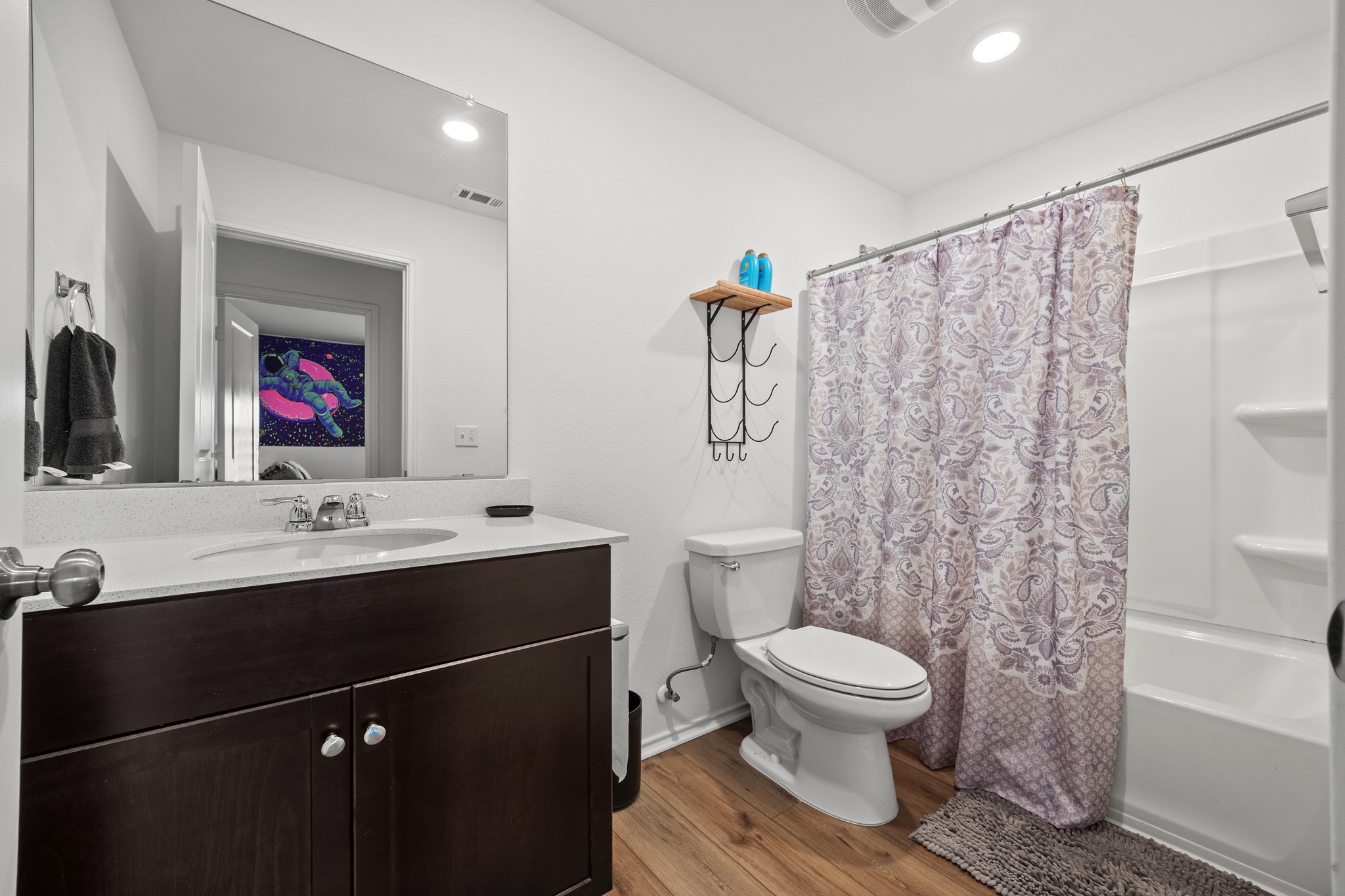 14121 Berning Road Manor, TX 78653 - Photo 19 of 27 A well-appointed bathroom features a dark wood vanity with ample counter space and a spacious shower.