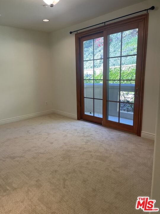 11357 Ovada Place, Unit 2 Los Angeles, CA 90049 - Photo 5 of 13 a view of an empty room with a balcony