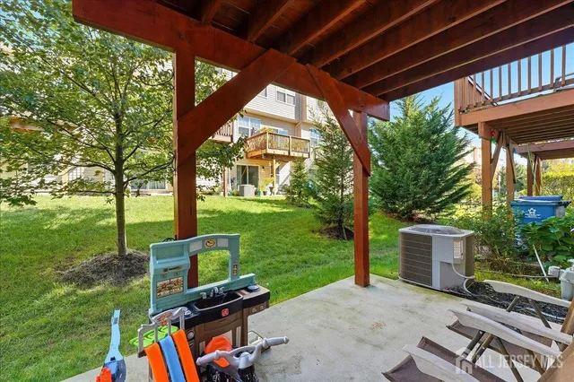 a view of a porch with furniture and a yard