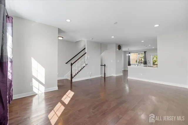 a view of a kitchen with furniture and wooden floor