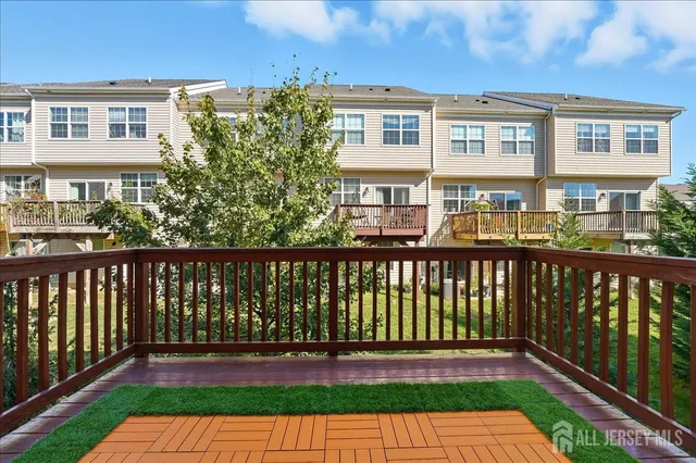 a balcony with wooden floor and fence