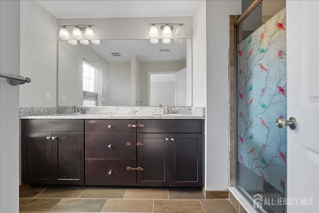 a bathroom with a granite countertop sink vanity and a mirror