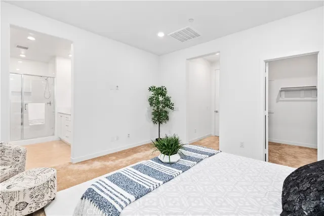 a bedroom with a bed and a potted plant
